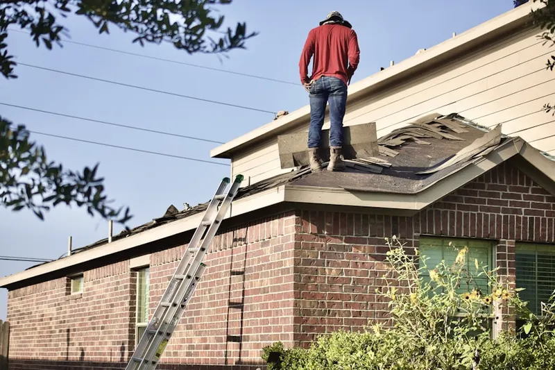 Professional roofer working on a residential roof in Campobello
